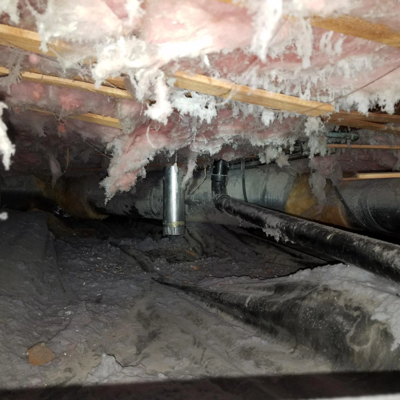 a worn out crawlspace with dirty ventilation